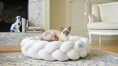 Вижте изображението в галерията, Cat lying on a white braided pet bed in a cozy living room.
