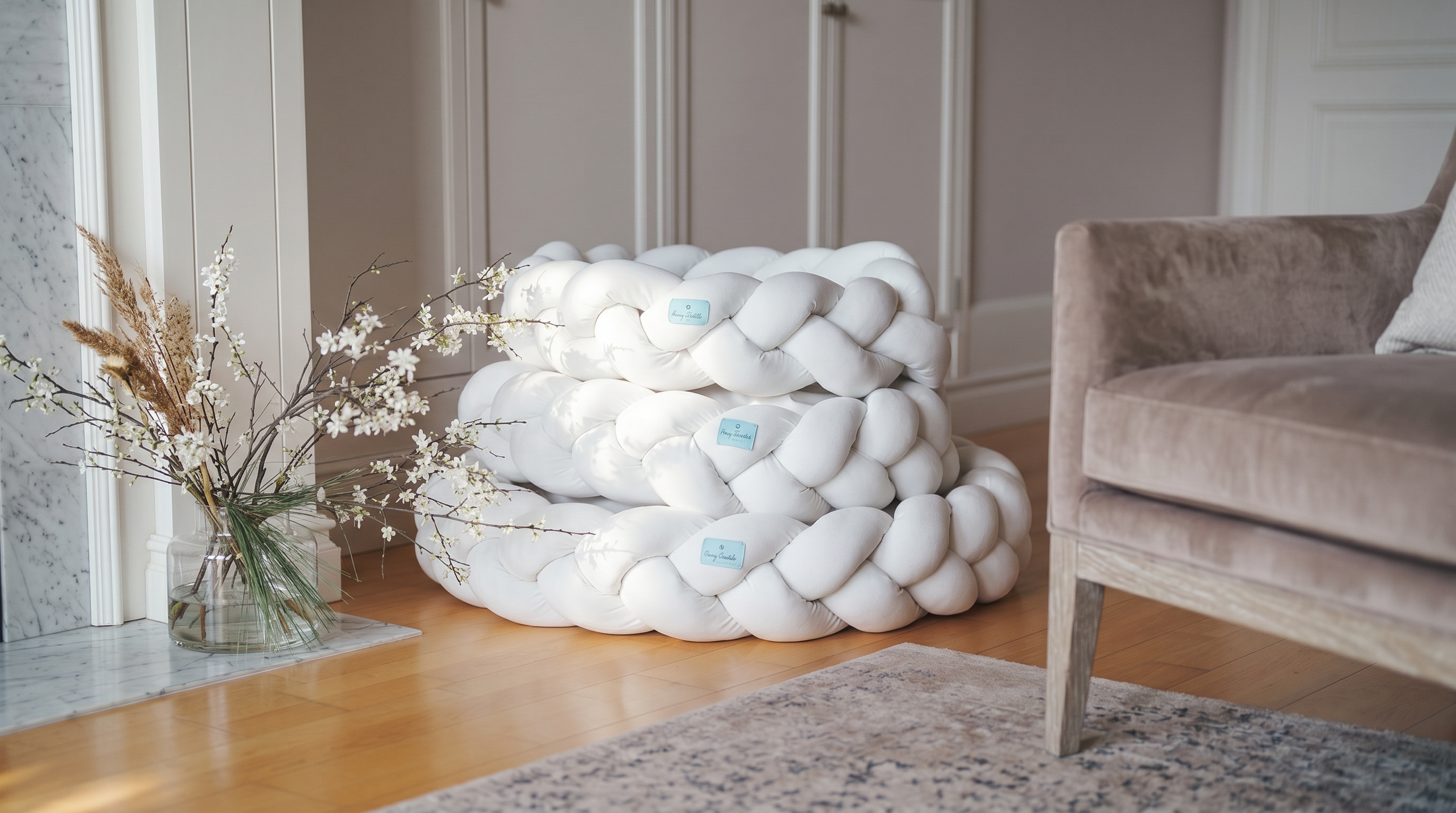 White braider dog bed in a room with a chair and decorative elements.